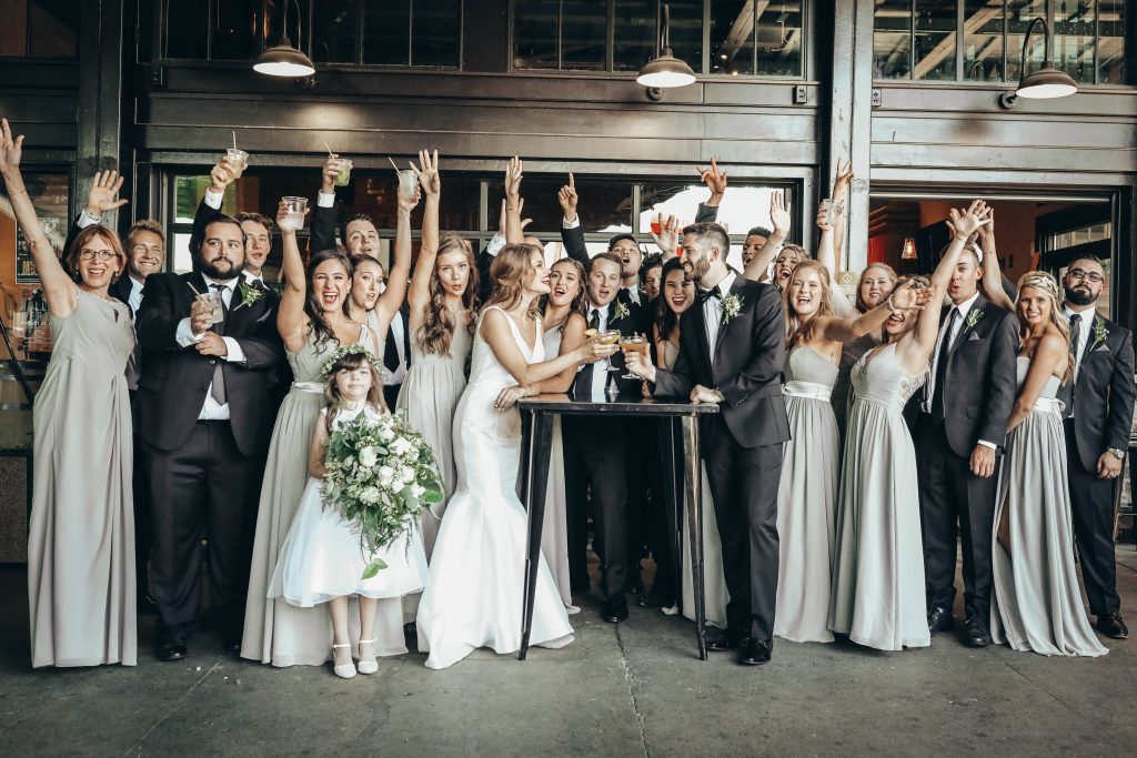 bridal party cheers and celebrates the fun couple on their wedding day