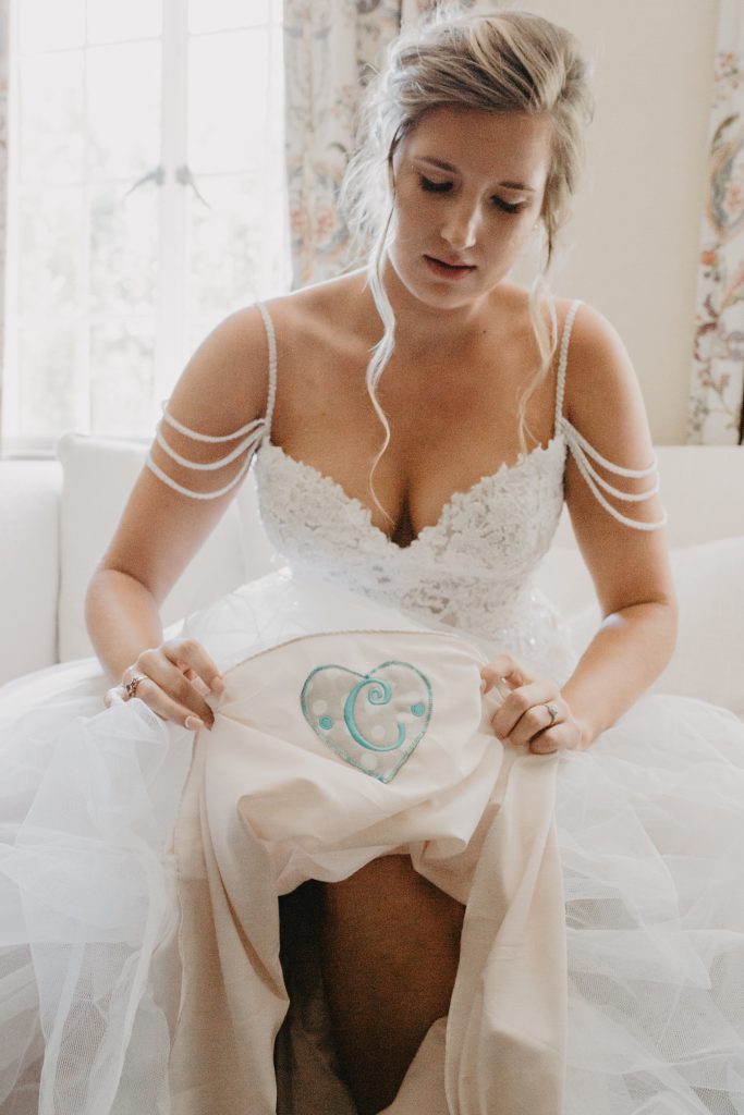 Bride shows patch sewn into her wedding dress