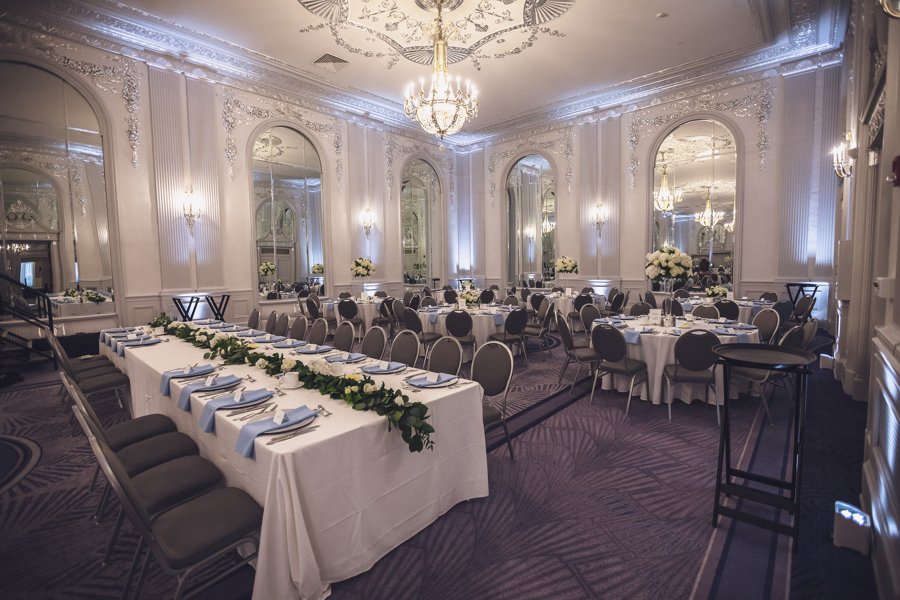 The silver ballroom with floral garland centerpieces and beautiful lighting.
