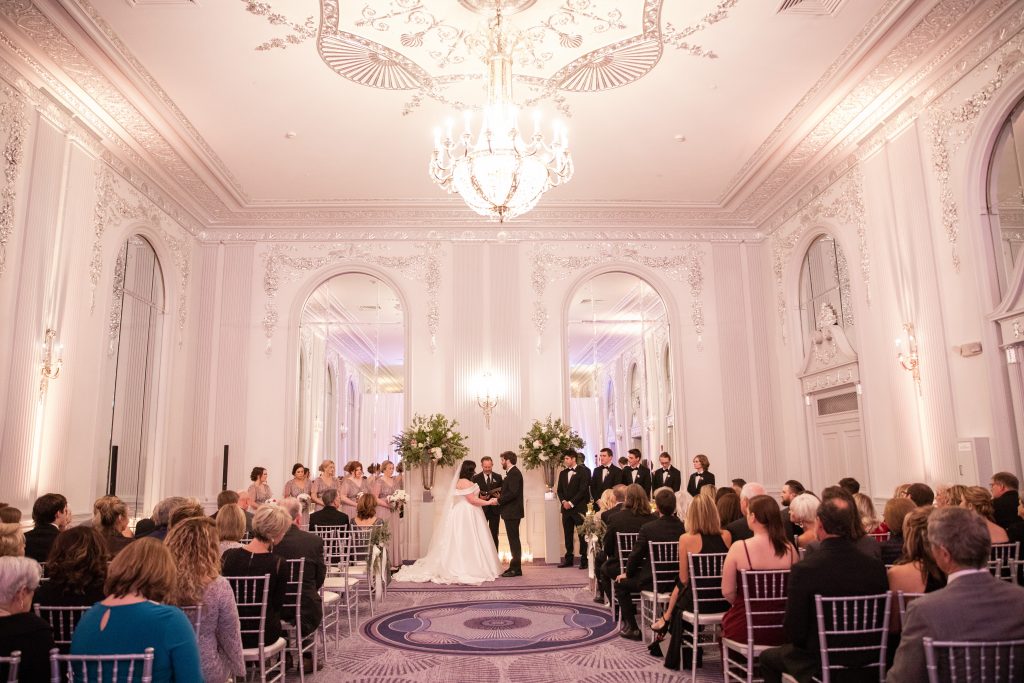 Bride and groom get married in luxury ballroom