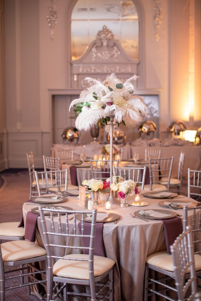 Feather florals tall centerpiece with chiavari chairs in a ballroom