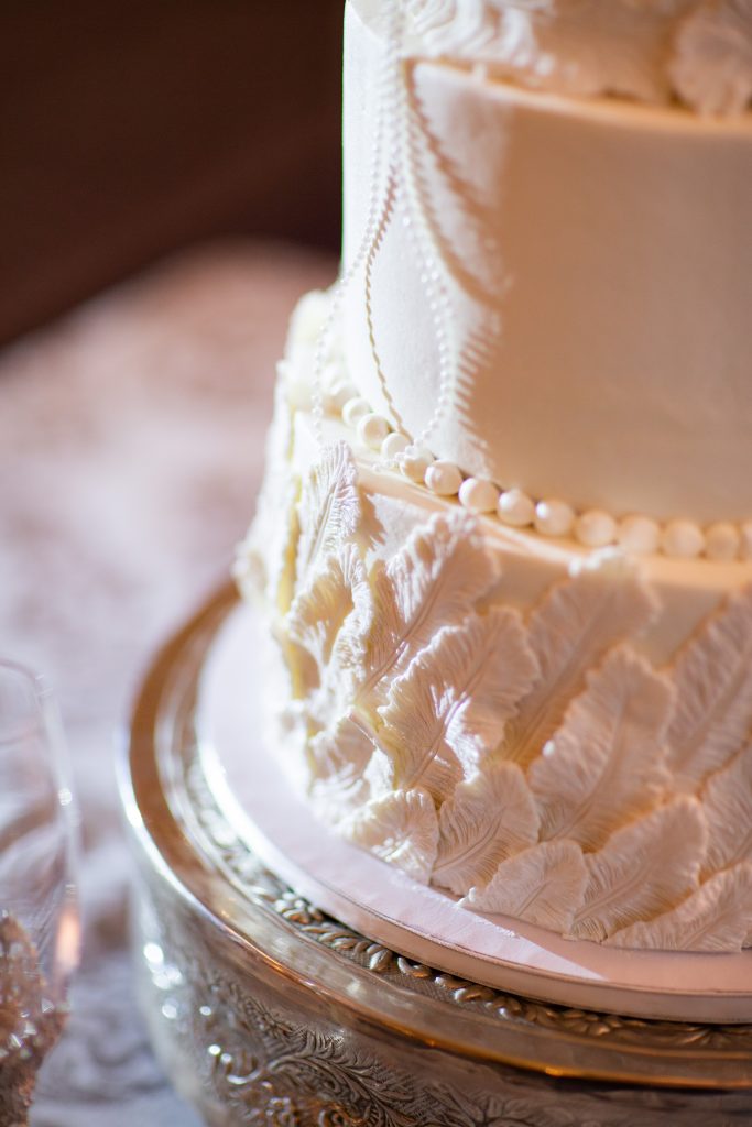 Beautiful wedding cake with feather details!