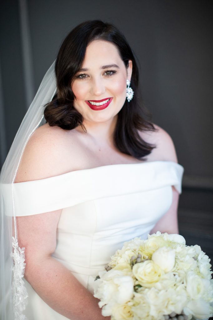 Luxury Bride with red lipstick holding her bouquet