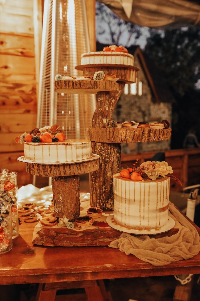 Varied sizes of caramel drizzle cakes with a cool tree cake stand.