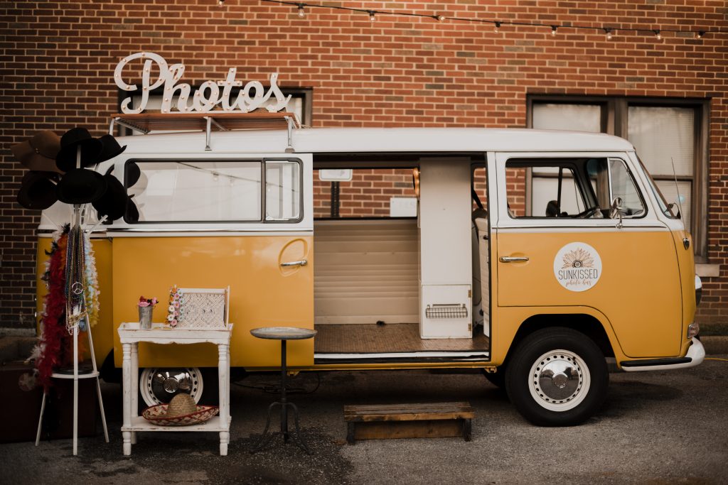 Miss Daisy, the sunkissed photobus was set up in front of the brick building at the open house party.